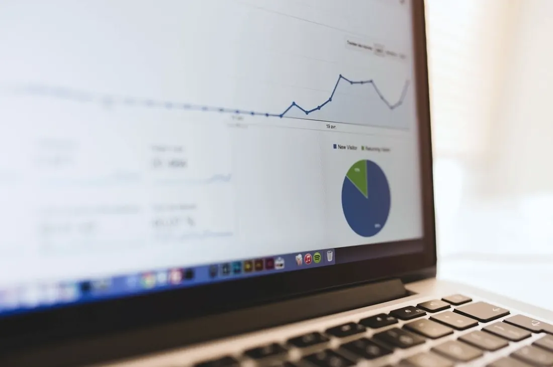 A laptop showing business charts and figures